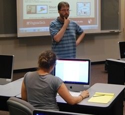 lecturer talking to sitting students